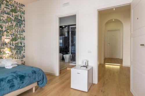 a bedroom with a bed with a blue bedspread at Relais San Demetrio - Modern & Central rooms in Salerno
