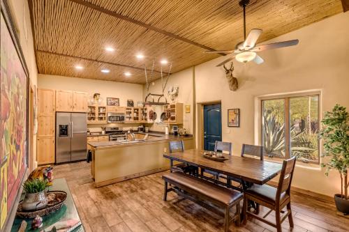 a kitchen with a table and a ceiling fan at Peaceful Desert Retreat - Stunning Views - Pool Spa, Backyard, Music - Tucson ! in Tucson