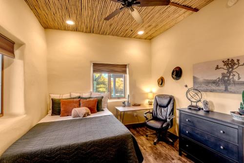 a bedroom with a bed and a desk and a chair at Peaceful Desert Retreat - Stunning Views - Pool Spa, Backyard, Music - Tucson ! in Tucson