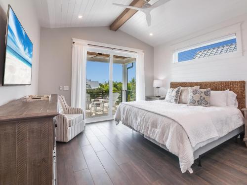 a bedroom with a bed and a sliding glass door at Luxe Island Escape in Anna Maria