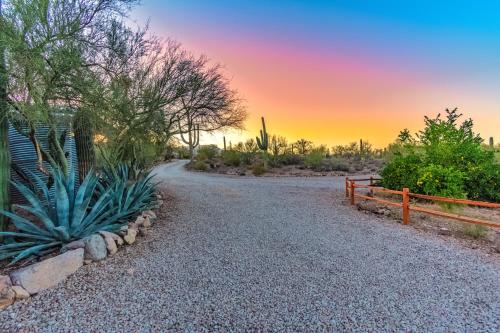 a gravel road in the desert at sunset at Peaceful Desert Retreat - Stunning Views - Pool Spa, Backyard, Music - Tucson ! in Tucson