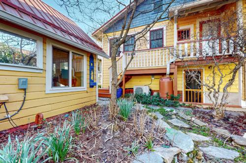 a yellow house with a yard in front of it at Zen Studio in Asheville