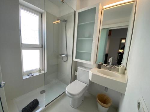 een badkamer met een toilet, een wastafel en een douche bij Privilege Menorca Apartment in Mahón
