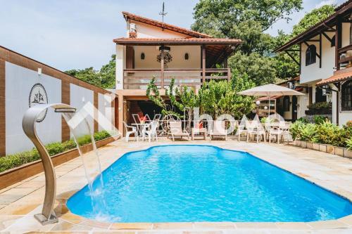 una piscina di fronte a una casa di Casa com piscina natural e lazer em Guapimirim a Guapimirim