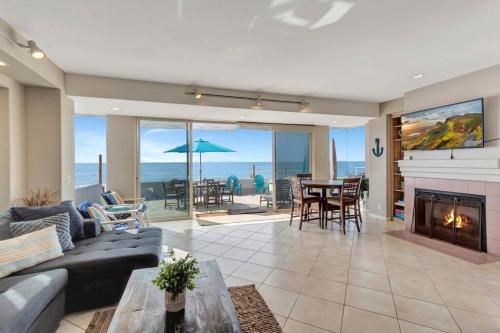 a living room with a couch and a fireplace at OCEAN FRONT - STUNNING VIEWS- VACATION PARADISE!! in Dana Point