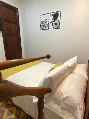 a bedroom with a bed with a bike on the wall at Hotel Boutique Iyarí in Palmira