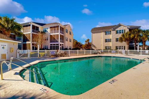 a swimming pool in front of a apartment building at Ocean Keyes 503 in Myrtle Beach