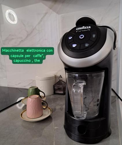 a black and white coffee maker on a counter at Centro storico, Centralissimo LUXURY SMERALDO SUITE Doccia Idromassaggio , cesto con piccola colazione in Ravenna