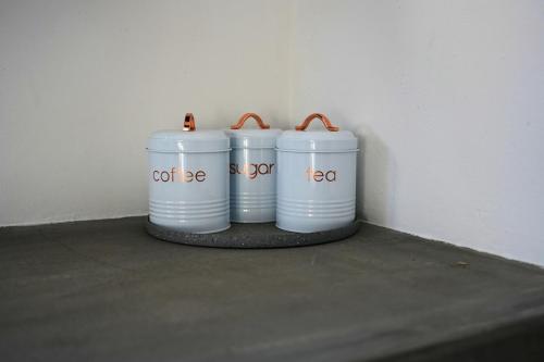 three white barrels sitting next to a wall at Casita Cumbrera en Penonomé in Penonomé