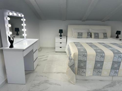 ein Schlafzimmer mit einem Bett, einem Waschtisch und einem Spiegel in der Unterkunft Apartma 78 in Koper