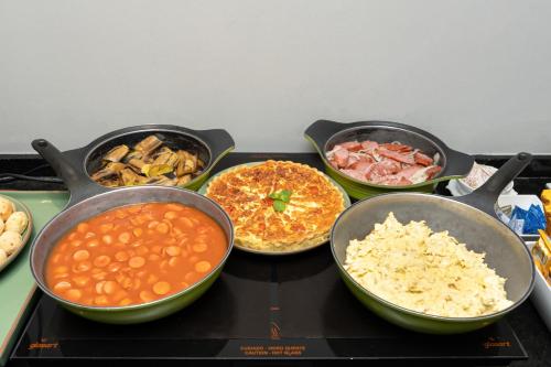 a group of different types of food on a stove at Slim São Paulo Congonhas in Sao Paulo