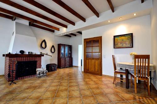 a living room with a table and a fireplace at Biała Akacja Resort & Business in Prudnik