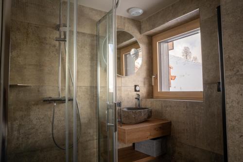 a bathroom with a sink and a glass shower at Horizon Blanc - Chalets dans les 2 Alpes in Les Deux Alpes