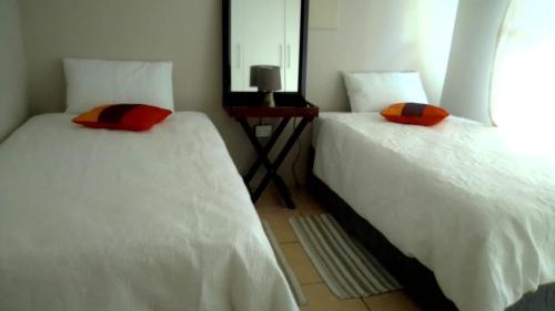 two beds sitting next to each other in a room at Vee’s Guest House in East London