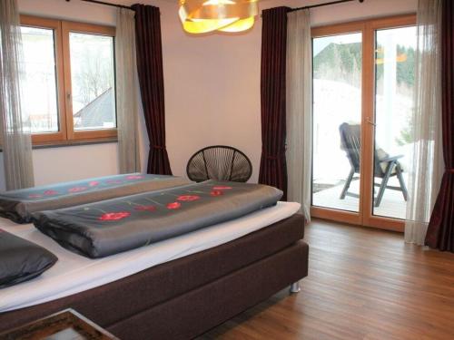 a bedroom with a large bed with avertisement at Alpchalet Staufner Quelle in Oberstaufen