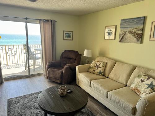 a living room with a couch and a table at Four Winds 402 by ALBVR - Amazing beachfront condo with private balcony & unbelievable views! in Orange Beach