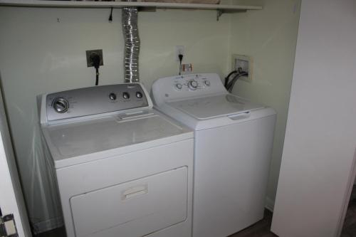 a white washer and dryer in a small room at Four Winds 402 by ALBVR - Amazing beachfront condo with private balcony & unbelievable views! in Orange Beach