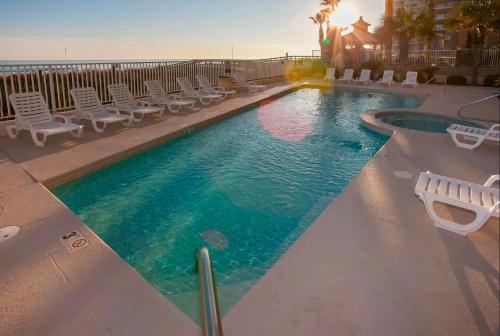 a large swimming pool with chairs at Four Winds 402 by ALBVR - Amazing beachfront condo with private balcony & unbelievable views! in Orange Beach