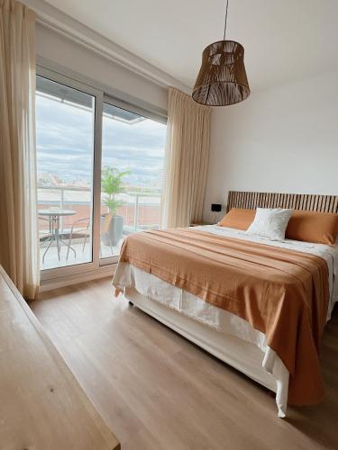 a bedroom with a bed and a large window at Dorrego 1781 in Buenos Aires