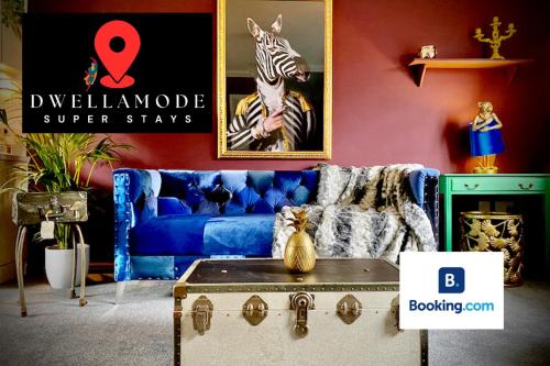 a living room with a blue couch and a zebra poster at 2 Bedroom Apartment - Disc0unts - Parking, Contractors, Group, Family in Canterbury