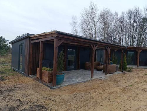 a house with a greenhouse with plants in it at Domki303 in Mszczonów
