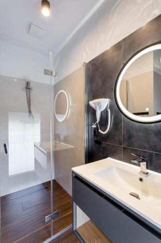 a bathroom with a sink and a mirror at ARAMIKA apartamenty in Szklarska Poręba
