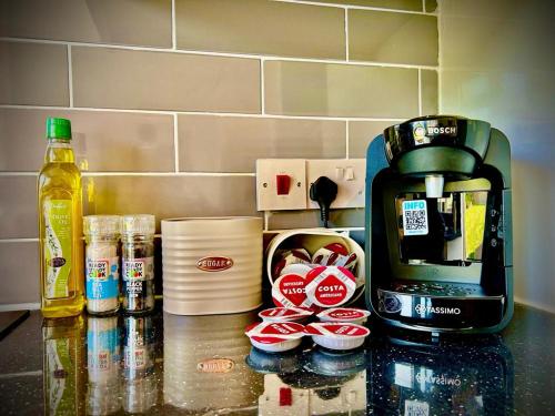 a counter top with a coffee maker and some cups at 2 Bedroom Apartment - Disc0unts - Parking, Contractors, Group, Family in Canterbury