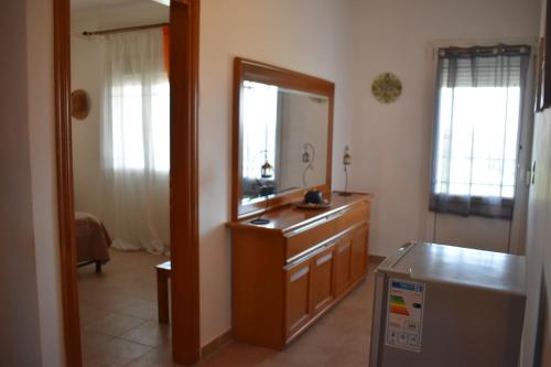 a bathroom with a mirror and a dresser with a sink at Casa Milady in Sozopolis, Halkidiki in Sozopoli