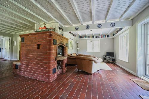 a living room with a brick fireplace and a couch at Haus-unter-Reet in Nebel