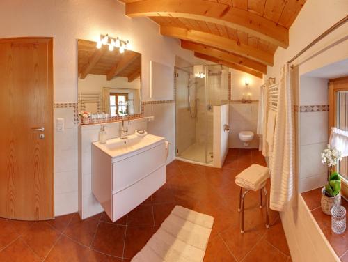 a bathroom with a sink and a shower at Ferienhaus Naturzauber - Chiemgau Karte in Inzell