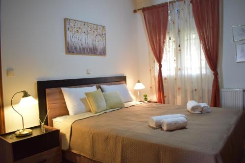 a bedroom with a large bed with two towels on it at Casa Milady in Sozopolis, Halkidiki in Sozopoli