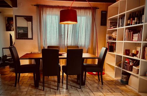 a dining room table with chairs and a red light at La Croisée des Chemins 