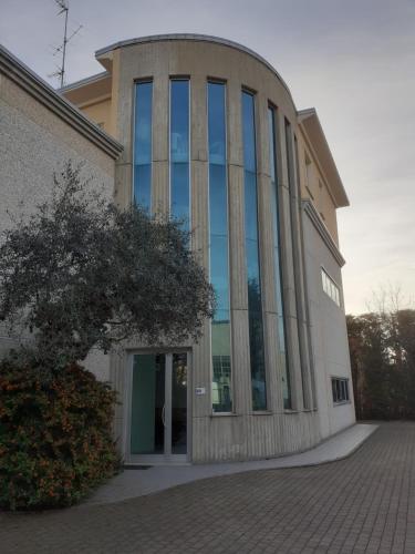 a building with large glass windows on the side of it at GOLD HOUSE in Maranello