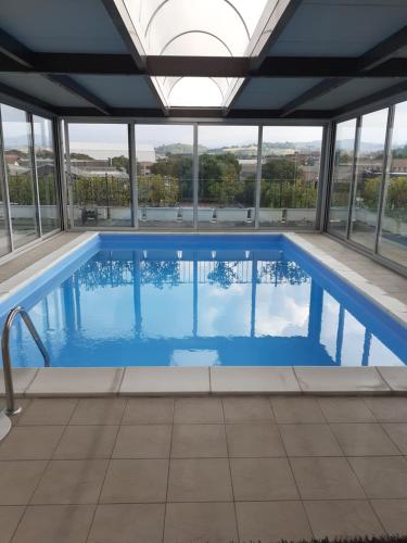 a large swimming pool with windows in a building at GOLD HOUSE in Maranello