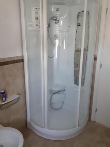 a white refrigerator in a bathroom next to a toilet at GOLD HOUSE in Maranello