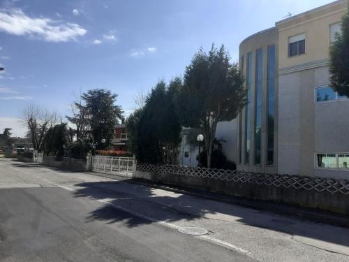 an empty street in front of a building at GOLD HOUSE in Maranello
