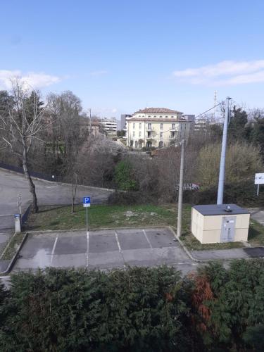 an empty parking lot next to a street at GOLD HOUSE in Maranello