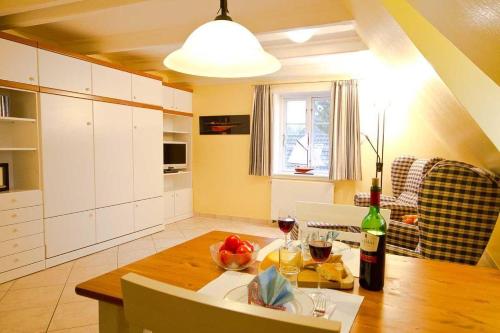 a kitchen with a table with a bottle of wine at Wohnung-Luv in Nebel