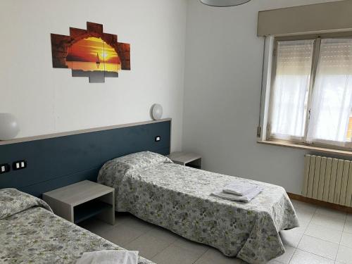 a bedroom with two beds and a window at La voglia in Villanova sullʼArda