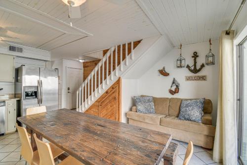 a kitchen and living room with a table and a couch at Next to Gulf Shores Public Beach Condo with Pool! in Gulf Shores