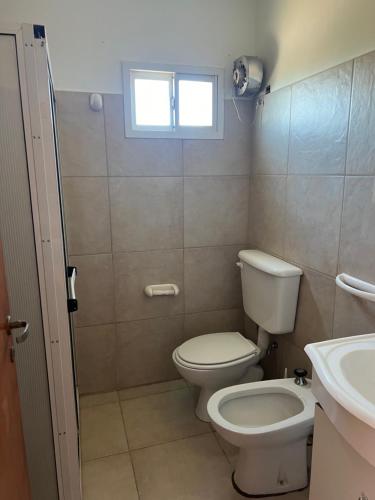 a bathroom with a toilet and a sink at Departamento céntrico in Monte Hermoso