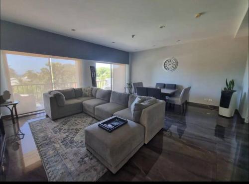 a living room with a couch and a table at Casa Bella in Jacó