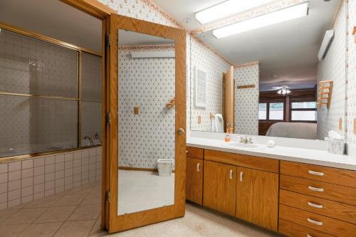 a bathroom with a shower and a sink and a mirror at Tyrolean 1 Vail Village in Vail
