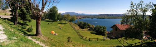 a field of grass with a lake in the background at The Lake - Casa Vacanza in Dormelletto