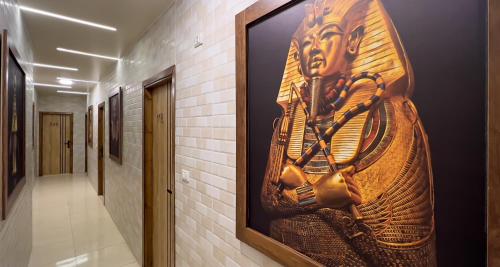 a large painting on a wall in a hallway at Giza Pyramids View Inn in Cairo