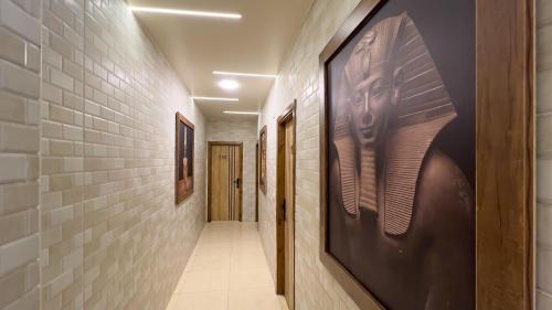 a hallway with paintings on the wall of a hallway at Giza Pyramids View Inn in Cairo