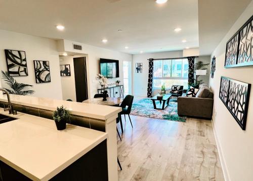 a living room with a kitchen and a living room with a couch at Century City Chic 4 sleep free parking 402 in Los Angeles