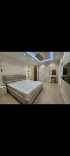a large bedroom with a large bed in it at Capital City in Madaliabad