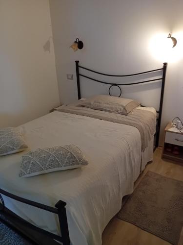 a bedroom with a large bed with white sheets and pillows at CAMPEGGIO PARCO DEI PINI in San Feliciano