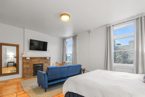 a bedroom with a bed and a tv and a fireplace at Library Square Suites in Toledo
